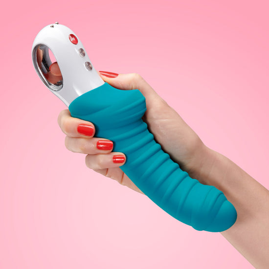 Woman's hand holding Fun Factory's Tiger vibrator